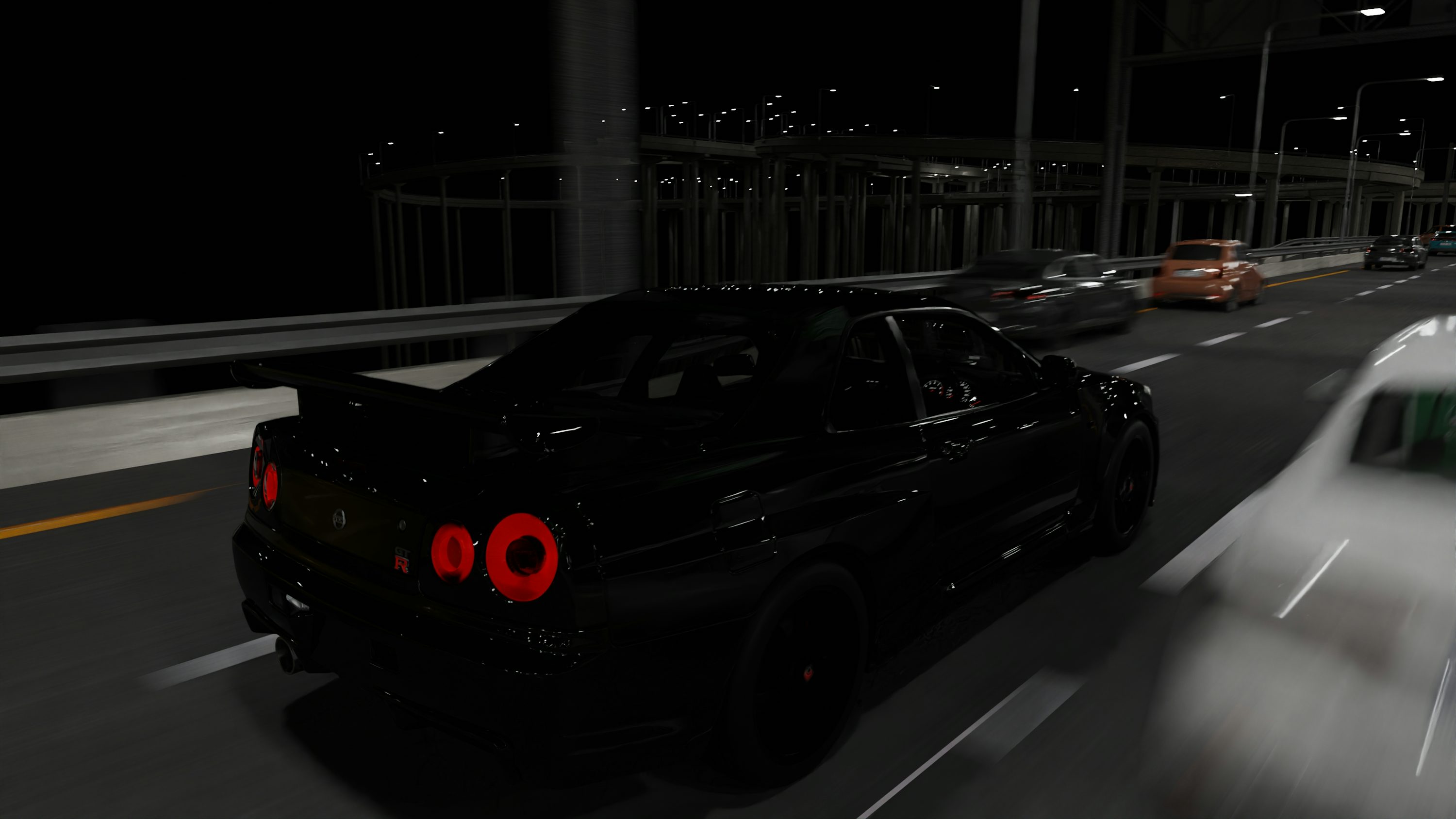 Black luxury sports car driving at night