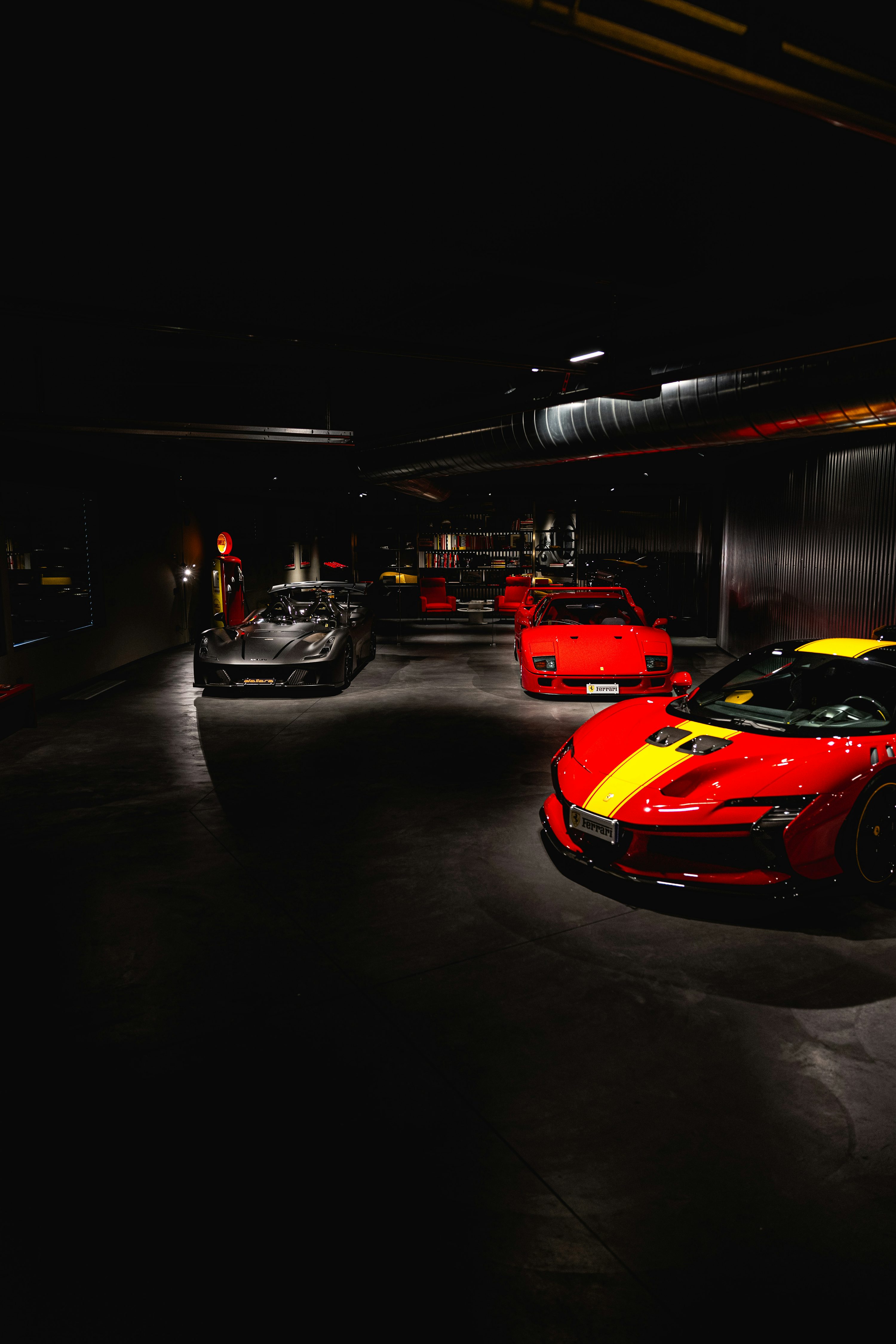 Red and black supercars in a showroom