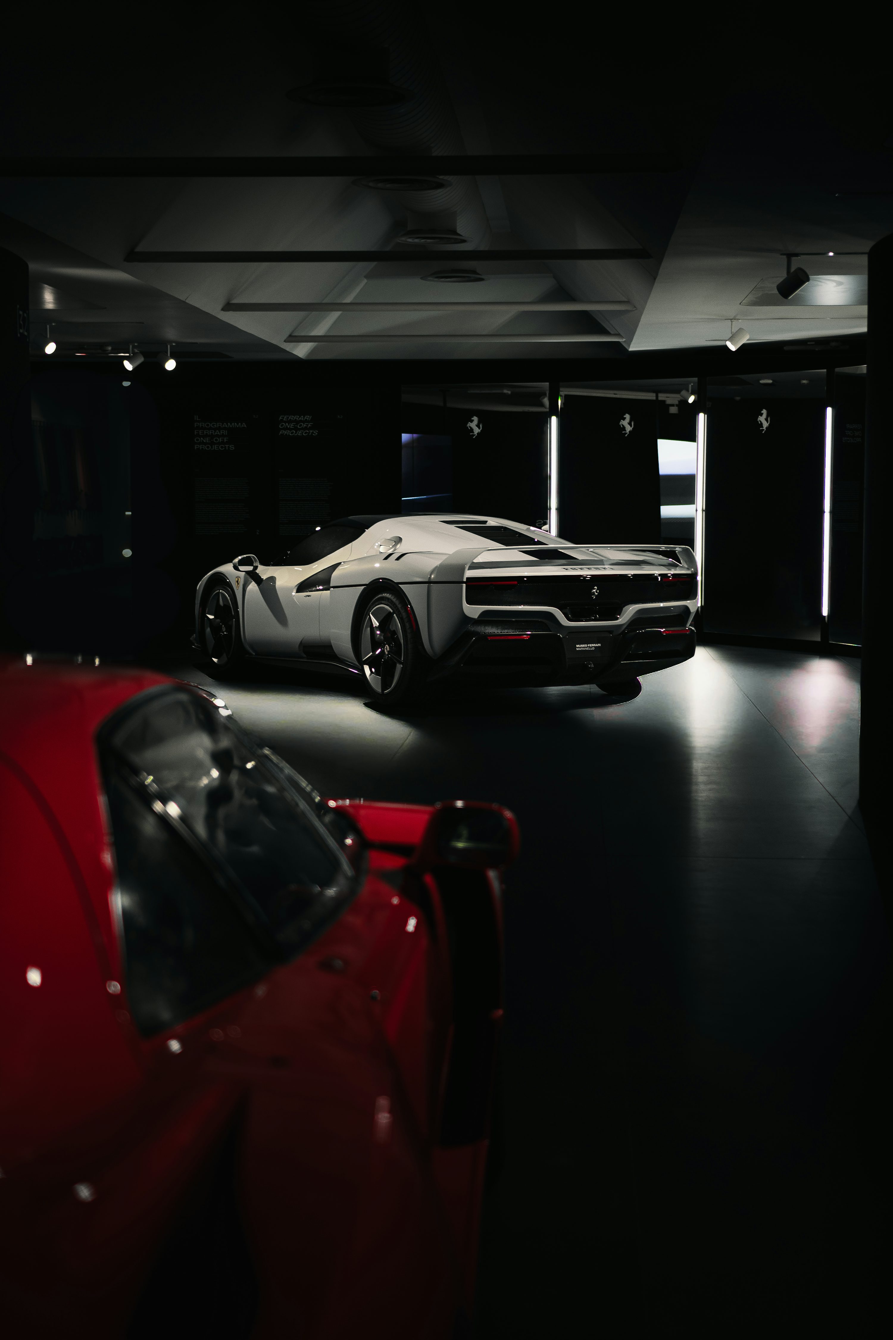 White luxury sports car displayed in a showroom